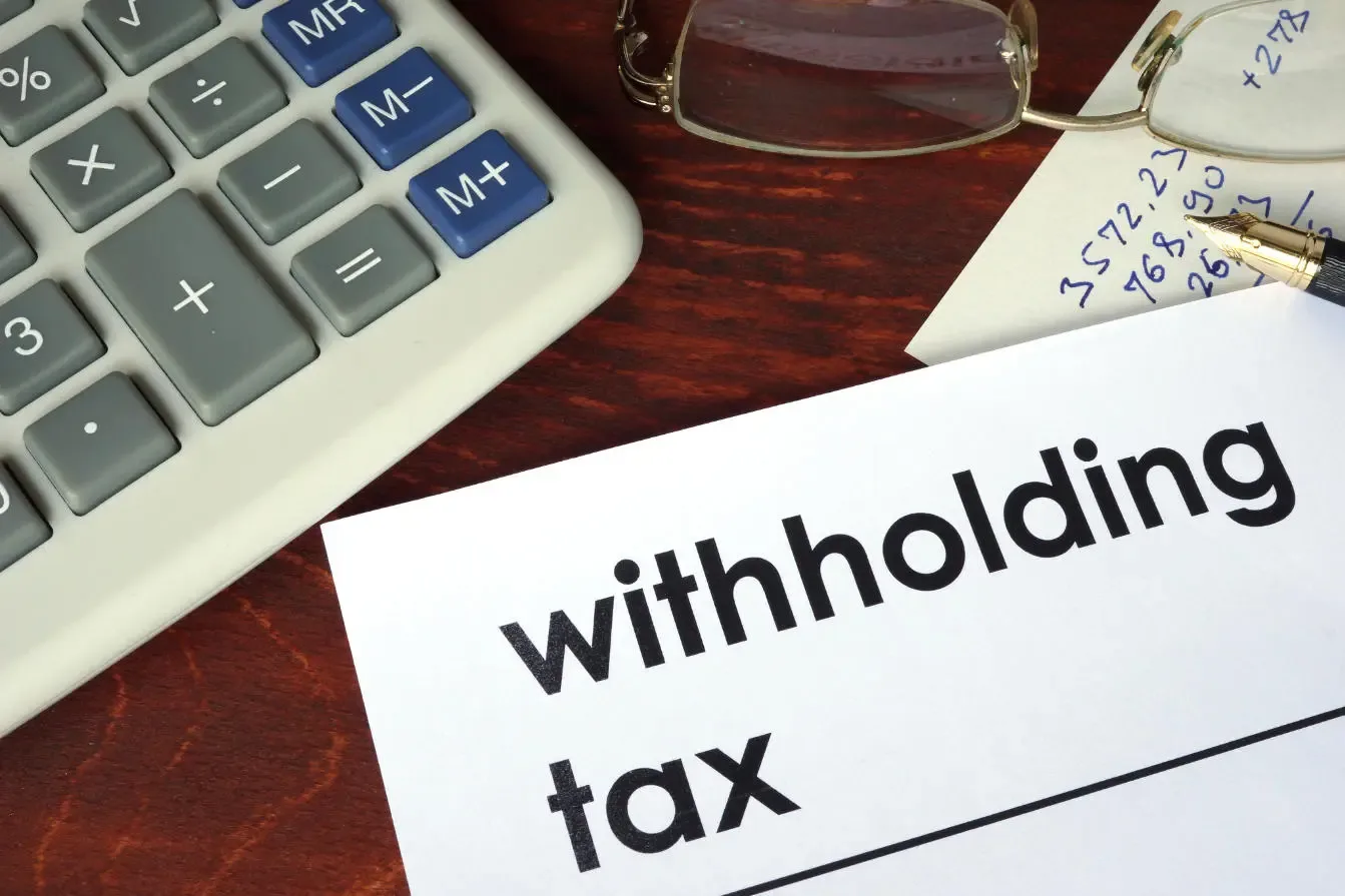 Withholding tax calculation concept with calculator, note, and tax document, Thailand tax submission and PND forms.