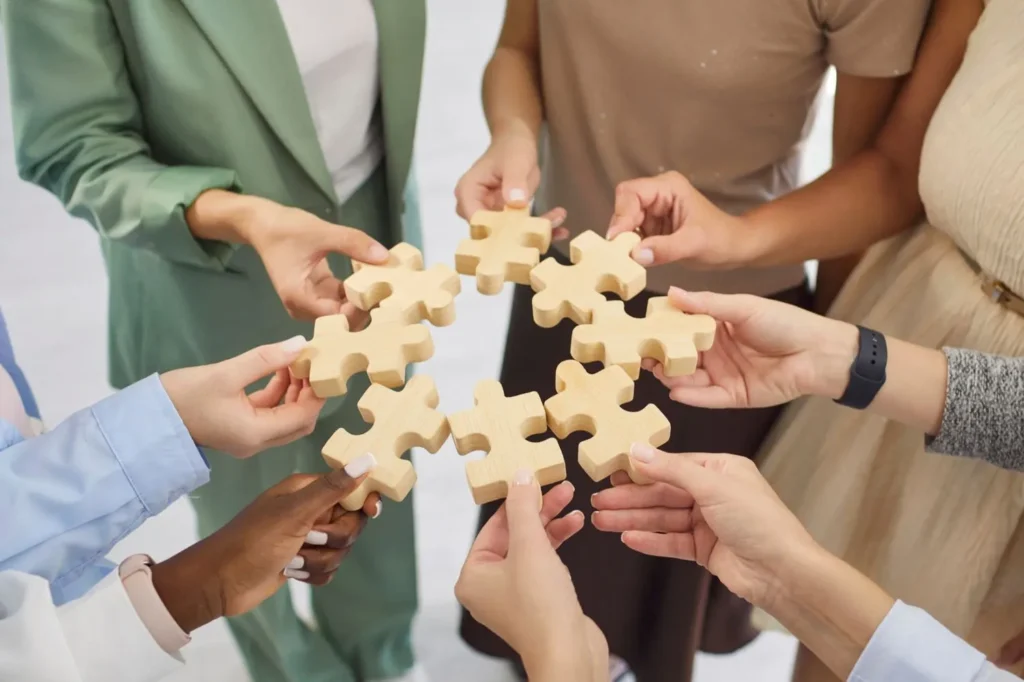 Business professionals connecting puzzle pieces symbolising structured share transfer process